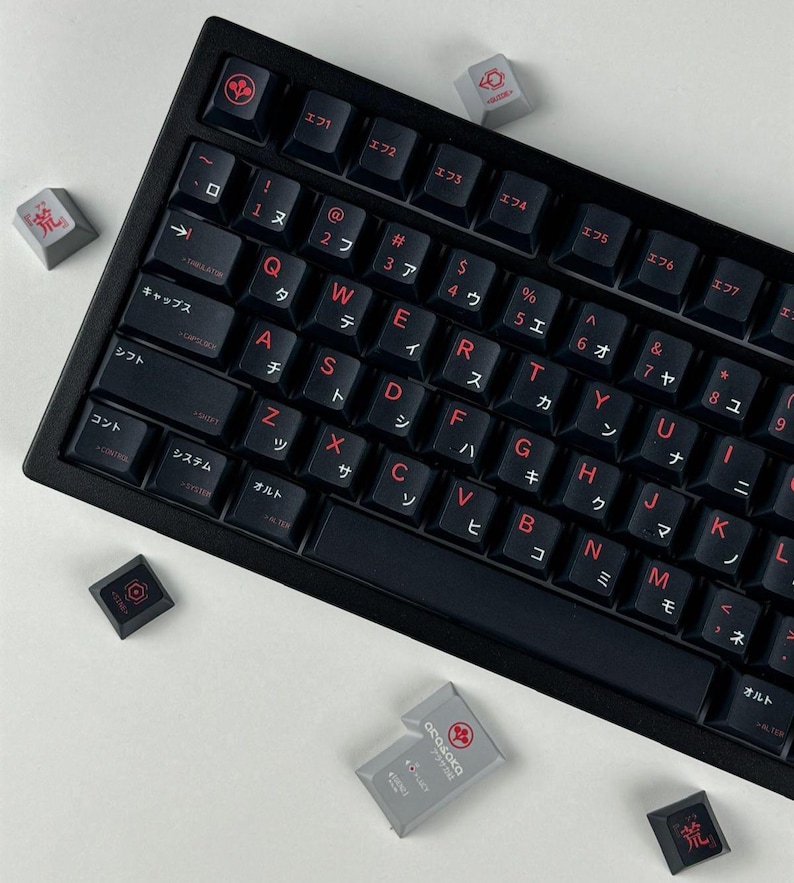 May include: A black mechanical keyboard featuring dark keys with red lettering, including Latin characters and Japanese katakana. Several loose gray and black keycaps with red symbols and the text Arasaka are scattered around the keyboard frame.