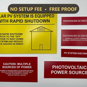 May include: A collection of rectangular safety signs for solar energy systems. One large yellow sign features black text and a house graphic. Several smaller red signs include white text labels such as Photovoltaic AC Disconnect and Caution.