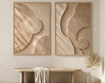 May include: Two rectangular wall art pieces featuring raised, textured beige geometric shapes including circles and curved lines. The artwork has a monochromatic sand-colored finish with a tactile, layered appearance, displayed in light wooden frames.