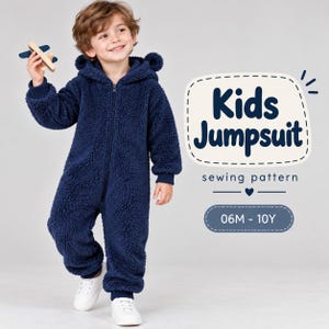May include: A navy blue fleece jumpsuit with a hood featuring bear ears, a front zipper closure, and ribbed cuffs. The text on the right reads Kids Jumpsuit sewing pattern 06M - 10Y. The garment is made of a textured, fuzzy material.