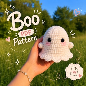 May include: A small, off-white crocheted ghost amigurumi with black safety eyes and pink embroidered cheeks. The text "Boo PDF Pattern" is displayed in white script, along with a small PDF icon graphic, indicating a digital crochet pattern.