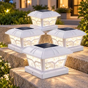 May include: A set of four white square solar post cap lights featuring a flat top with integrated solar panels and a clear, textured glass-like side panel design that emits a warm, glowing light from within the housing structure.