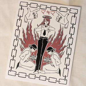 May include: A rectangular art print featuring a central figure with red hair and a halo, flanked by two kneeling figures in white coats. The design includes a chain border, hand gestures, eye symbols, and the Japanese text マキマ in red ink.