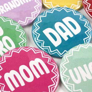 May include: A set of nine colorful round buttons with white text. The buttons feature the words "Big Bro", "Mom", "Dad", "Grandma", "Grandpa", "Uncle", "Sister", "Brother", and "Auntie".