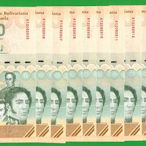 May include: A stack of ten 500 Bolívares banknotes from the República Bolivariana de Venezuela. Each light tan bill features the portrait of Simón Bolívar, a sailing ship, the number 500, and unique serial numbers starting with A12062605.