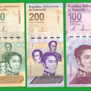 May include: Three Venezuelan banknotes in denominations of 500, 200, and 100 Bolívares. The 500 note is orange, the 200 is tan, and the 100 is purple. Each bill features the text República Bolivariana de Venezuela and portraits of historical figures.