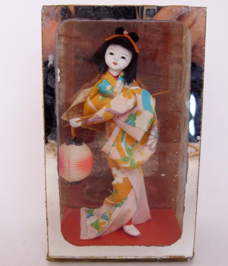 oriental dolls in glass cases