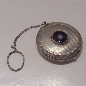 Art Deco Silver Rouge Powder Dance Compact has a Guilloche Black Enamel with Pink Rose Center as Well as Ring and Chain 2&quot; Diameter