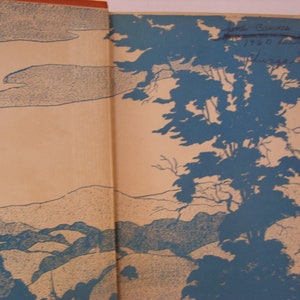 May include: A vintage book cover featuring a blue and white illustration of a landscape with trees and hills. The text "First Edition 1920" is visible on the cover.