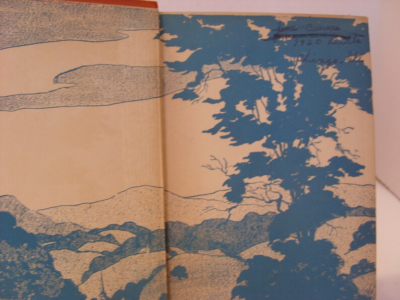 May include: A vintage book cover featuring a blue and white illustration of a landscape with trees and hills. The text "First Edition 1920" is visible on the cover.