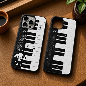 May include: Two black and white phone cases featuring a piano keyboard pattern. The design includes musical notes, small stars, and a cartoon puppy character on the left case. The cases have a dark, glittery section on the left side.