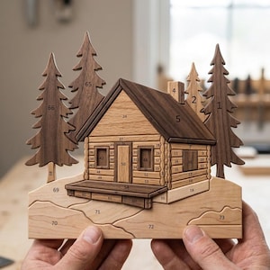 May include: A wooden puzzle shaped like a cabin in a forest, featuring light and dark wood tones. The cabin and trees are composed of interlocking pieces, each marked with a small black number. The scene depicts a house with a porch and chimney.