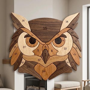 May include: A wall-mounted wooden owl puzzle featuring various shades of brown and tan wood grain. The owl head is composed of thirty-five interlocking pieces, each clearly labeled with a black number from one to thirty-five, forming a detailed avian face.