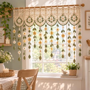 May include: A cream-colored crochet valance curtain featuring a scalloped top edge with floral motifs in white, yellow, and green. Multiple vertical strands hang from the valance, each decorated with small crocheted flowers and green leaves.