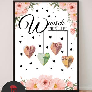 Puede incluir: Un póster enmarcado con el texto Wunsch ERFÜLLER en letras negras cursivas y de molde. El diseño incluye ilustraciones florales rosas en la parte superior e inferior, con cuatro recortes en forma de corazón que muestran billetes de euro.