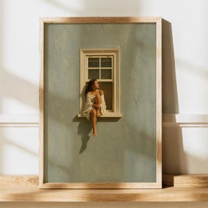 Pode incluir: Uma impressão de arte de parede emoldurada com uma parede verde-sálvia texturizada e uma janela. Uma pessoa com cabelos longos e escuros está sentada no parapeito da janela, envolta em um tecido branco, com os joelhos dobrados ao peito.