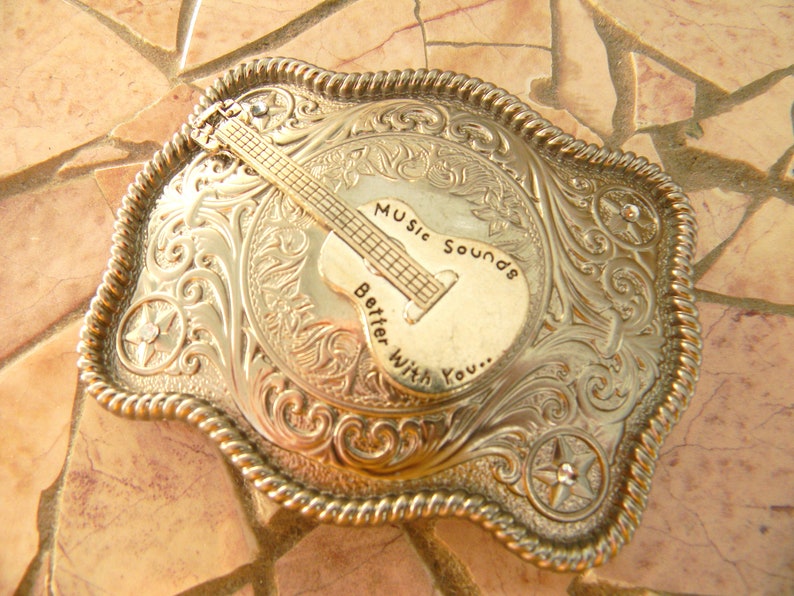 designer belt with guitar buckle