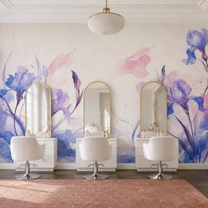 Puede incluir: Un mural de pared con una pintura de acuarela de flores de iris moradas y azules con suaves acentos rosados. El diseño se muestra en una habitación con tres sillas de salón blancas, tres espejos arqueados y una gran alfombra color terracota.
