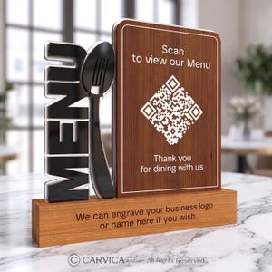 May include: A wooden table sign featuring a vertical board with a QR code, the text Scan to view our Menu and Thank you for dining with us. Beside it, a black 3D word MENU and a spoon icon stand on a wooden base with engraved text.