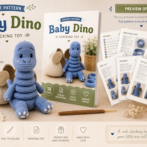 May include: A crochet pattern for a Baby Dino stacking toy, featuring a blue crocheted dinosaur toy, a printed instruction booklet with 14 pages, and a wooden crochet hook. The pattern includes step-by-step photos, material lists, and assembly instructions for creating the toy.
