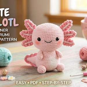 Peut inclure: Un jouet amigurumi axolotl crocheté rose clair avec des yeux noirs et des joues roses. Le texte indique CUTE AXOLOTL BEGINNER AMIGURUMI CROCHET PATTERN EASY PDF STEP-BY-STEP. Plusieurs pelotes de laine, perles et un crochet rose sont visibles.