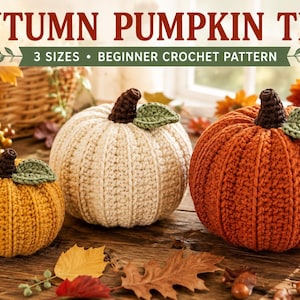 May include: A crochet pattern titled AUTUMN PUMPKIN TRIO 3 SIZES BEGINNER CROCHET PATTERN featuring three handmade pumpkins in yellow, cream, and orange with brown stems and green leaves, displayed on a wooden surface with autumn leaves.