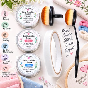 May include: Three round metal tins of heat erasable cream in white, red, and blue, each labeled 40g/can. Includes two black brushes with orange bristles, a roll of white tape, and sewing pins. Text reads: Mark Create Stitch Erase Repeat.