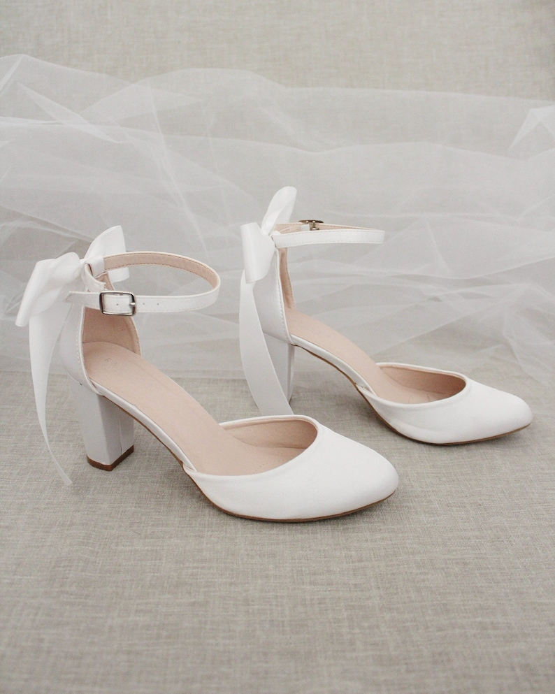 white heels with bows on the back