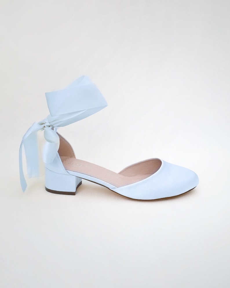 May include: Light blue satin heeled shoes with a matching satin ribbon tied around the ankle.