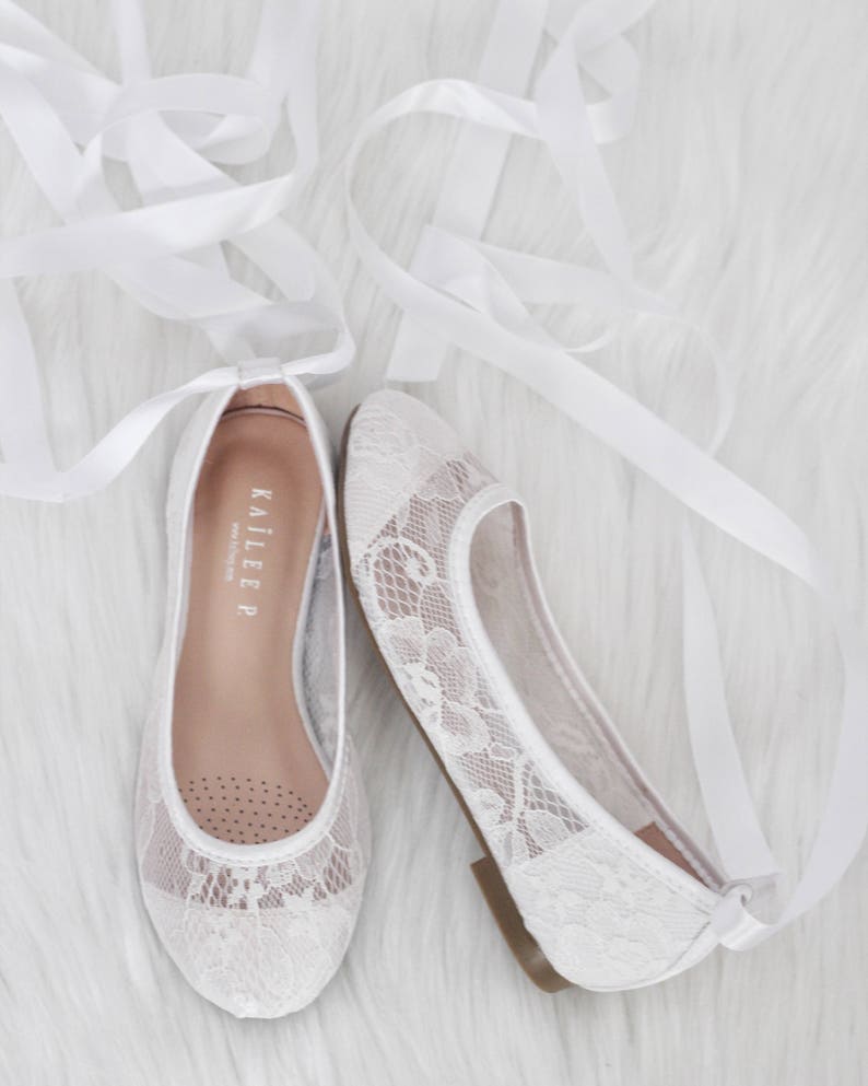 white flats with ribbon