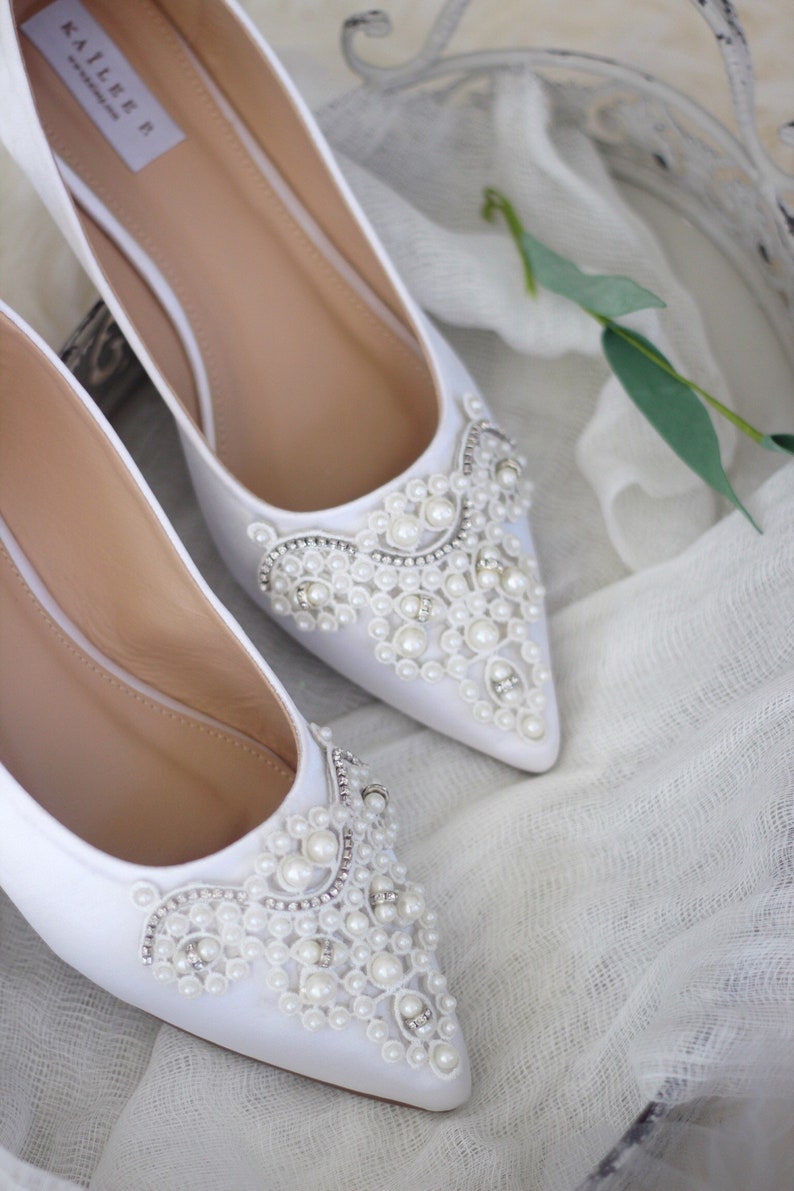white pointy flats