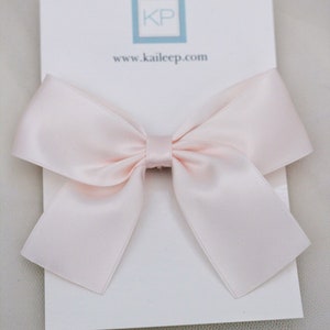 May include: A dusty pink satin bow on a white card with the text "www.kaileep.com" and "DUSTY PINK".
