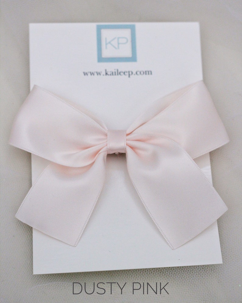 May include: A dusty pink satin bow on a white card with the text "www.kaileep.com" and "DUSTY PINK".