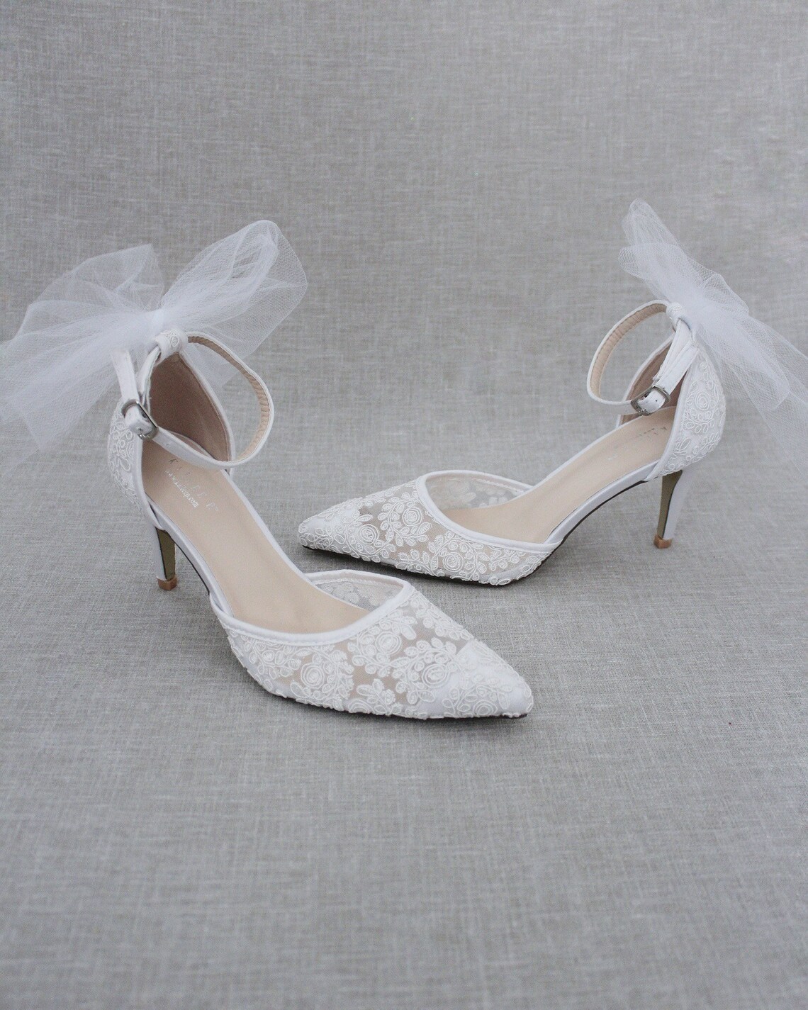 white heels with bows on the back