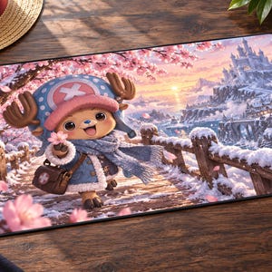 May include: A rectangular desk mat featuring a colourful illustration of the character Tony Tony Chopper from One Piece. The character wears a blue coat and hat, standing on a snowy bridge surrounded by pink cherry blossoms and a distant castle.