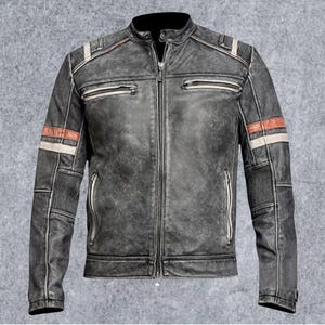 May include: A charcoal gray distressed leather jacket featuring a mandarin collar, a full-length front zipper, and two zippered chest pockets. The sleeves are accented with horizontal red and white stripes and ribbed panels at the elbows.
