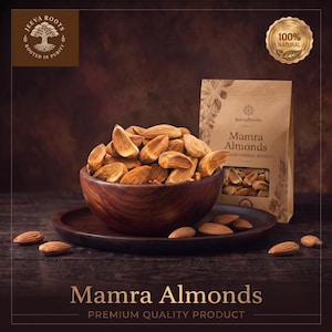 Könnte beinhalten: Eine Holzschale gefüllt mit Mamra-Mandeln steht auf einem passenden Holzteller, begleitet von einem beigen Papierbeutel mit der Aufschrift JeevaRoots Mamra Almonds Premium Herbal Remedy. Ein goldenes 100% Natural-Siegel und das JeevaRoots-Logo sind sichtbar.