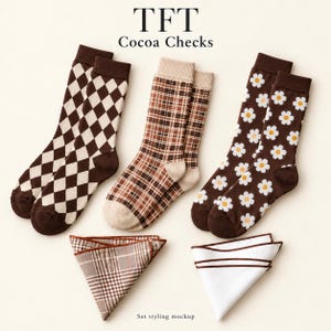 May include: Three pairs of crew socks and two folded pocket squares. The socks feature brown and cream argyle, brown plaid, and brown daisy patterns. The pocket squares include one brown plaid and one white with brown trim. Text reads TFT Cocoa Checks.