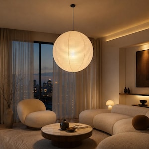 May include: A large, spherical paper pendant light fixture with a ribbed texture, suspended from the ceiling by a thin black cord. The lamp emits a warm, soft glow, illuminating the surrounding room with a diffused light in a circular shape.