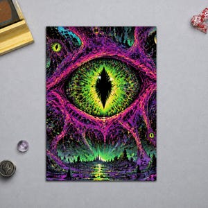 May include: A rectangular art print featuring a large, central green eye with a black vertical pupil, surrounded by vibrant purple and magenta organic, web-like structures. Below the eye, a dark, silhouetted landscape sits under a glowing green horizon.