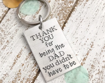 May include: Silver keychain with a rectangular tag that reads "Thank You for being the DAD you didn't have to be".