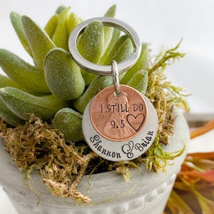 May include: A silver keychain with a 1998 penny that says "I Still Do" with a heart and the names "Shannon & Brian" engraved on the back.