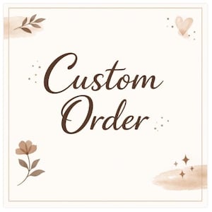 May include: A square sign with a cream background and a thin brown border. The text "Custom Order" is written in a dark brown cursive font in the center. The design features brown watercolor accents, a small heart, a flower, and star icons.