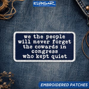 May include: A rectangular embroidered patch with a dark blue background and a white border. The patch features white embroidered text that reads: we the people will never forget the cowards in congress who kept quiet.
