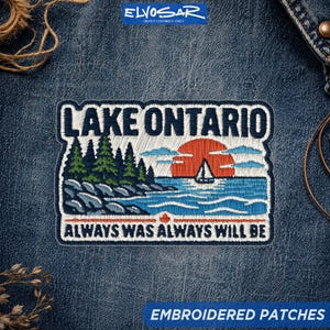 May include: A rectangular embroidered patch featuring a landscape of Lake Ontario with a dark blue sky, a red sun, a white sailboat, green pine trees, and rocky shores. The text reads LAKE ONTARIO and ALWAYS WAS ALWAYS WILL BE.