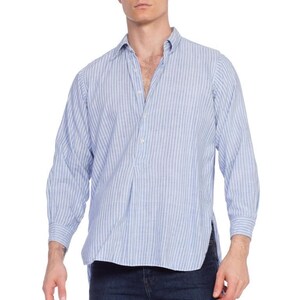 May include: A light blue striped long-sleeve shirt with a button-down collar and a single button placket. The shirt has a relaxed fit and a slightly longer length.