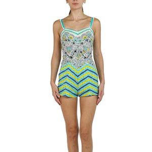 May include: A blue and yellow patterned romper with a white and black geometric print on the bodice. The romper has thin straps and a sweetheart neckline.