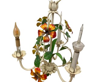 May include: A white metal chandelier with three lights and floral accents. The flowers are painted in shades of yellow, orange, and green.