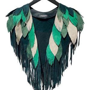May include: A green suede vest with a fringe trim and a layered feather design. The vest is on a black hanger with the word "MORPHEW" printed on it.