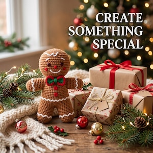 May include: A brown crocheted gingerbread person doll with a red and green bowtie, white icing-style trim, and dark eyes. The text "CREATE SOMETHING SPECIAL" is visible above the doll, surrounded by wrapped gifts, pine branches, and ornaments.